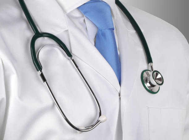 istock Doctor in white lab coat with stethoscope hung around his neck 1285513691