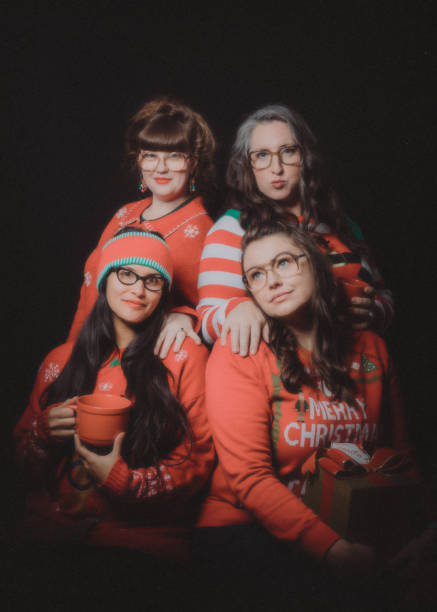 Christmas Ugly Sweater Retro Portrait With Friends A group of adult women friends celebrate the holiday taking a portrait wearing "ugly" Christmas sweaters.  Vintage styled portrait in 1980's style. 1980 photos stock pictures, royalty-free photos & images