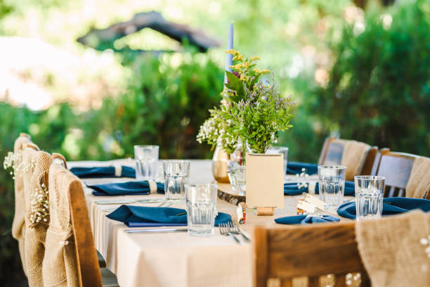 istock Outdoor wedding table decoration with fresh flowers and blank table cards. Special event table set up. Boho wedding decoration. 1285514498