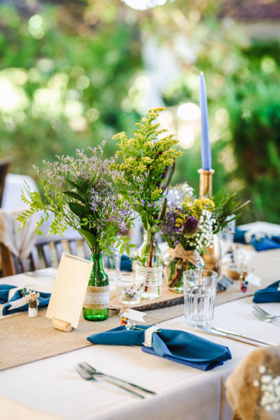 istock Outdoor wedding table decoration with fresh flowers and blank table cards. Special event table set up. Boho wedding decoration. 1285514509