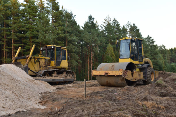 istock Dozer and Vibro Roller Soil Compactor at road construction and bridge projects in forest area. 1285515615