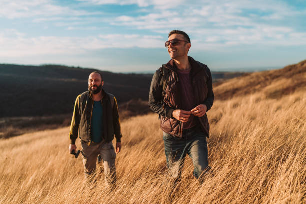 istock Two happy friends hiking in the hills 1285515963