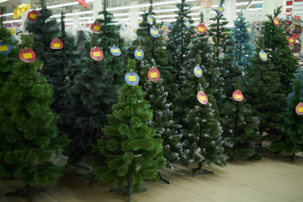 Selling PVC Christmas Trees in the Mall stock photo