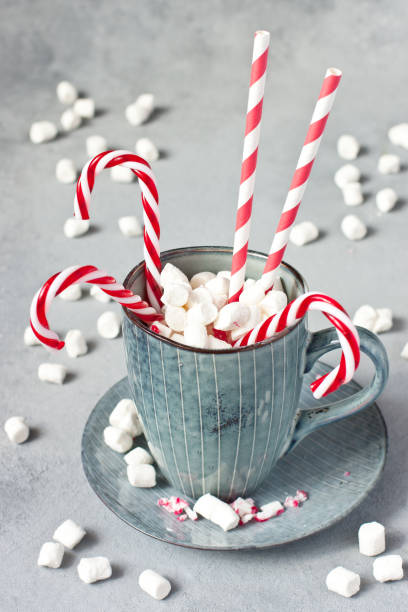 istock Nice Christmas mug with candy canes and fluffy marshmellows, selective focus 1285518184