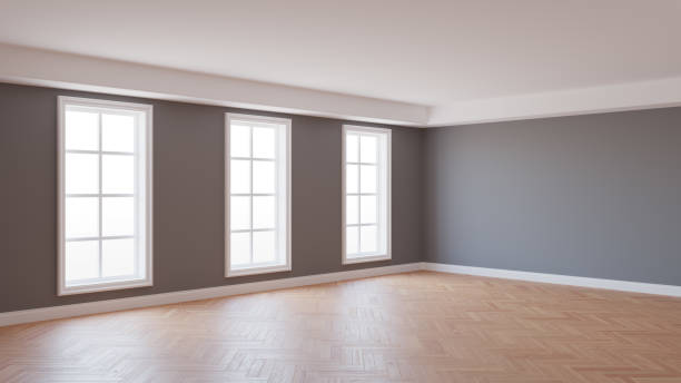 istock 8K Ultra HD Interior Corner with Gray Walls, Parquet Floor, Three Large White Windows and a White Plinth with Work Path on Windows. 3d render, 7680x4320 1285519006