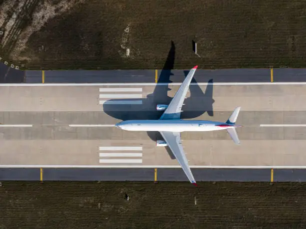Aerial drone photo of air planes as seen from above docked in airport space