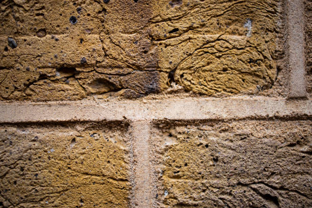Close-up at orange clay stone brick wall of the retro style building exterior.