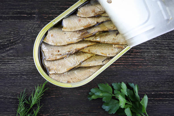 istock sprats in a tin can on a wooden background 1285520483