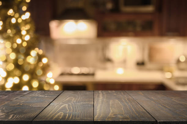 wooden countertop and blurred kitchen with christmas tree. background for display or montage your products. - christmas table imagens e fotografias de stock