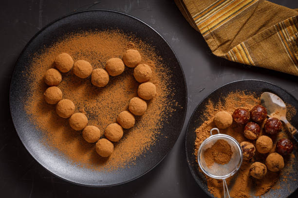 istock chocolate truffles or energy protein balls made with dry dates, walnuts, raisins, covered by cocoa powder 1285521428