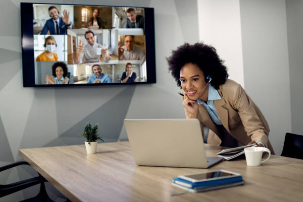 istock Happy black businesswoman using laptop while having conference call with her colleagues. 1285523360