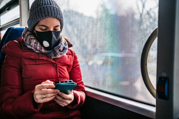 istock Woman in bus wearing face mask 1285523715