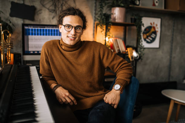 istock Portrait of young smiling handsome piano player 1285524639