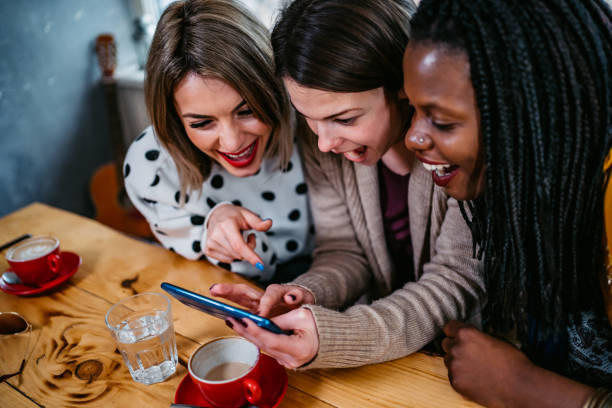 istock Three women checking social media together 1285525080