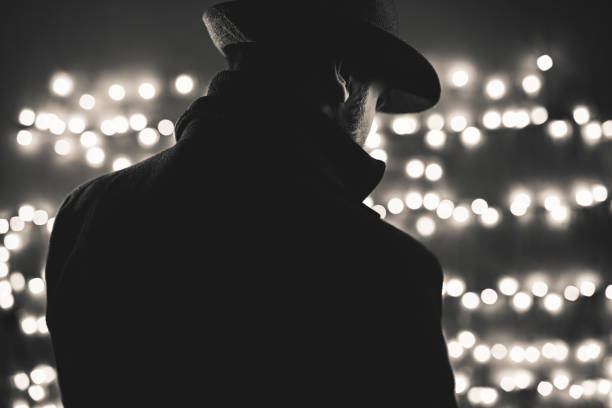 Retro man wears coat and hat Retro man wears coat and hat, black and white. Noir style. film noir style photos stock pictures, royalty-free photos & images
