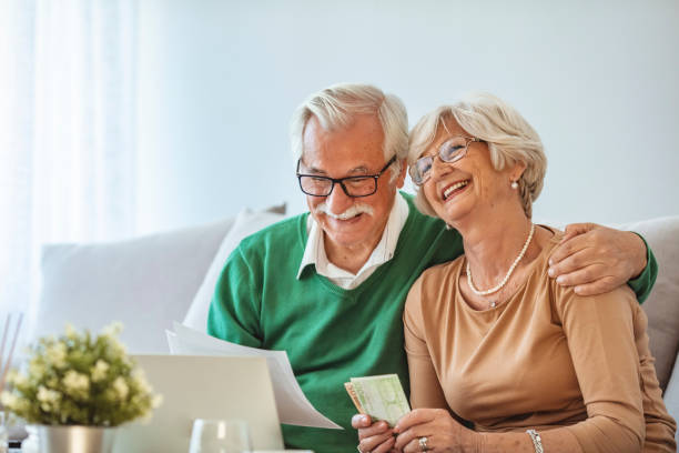 istock Happy mature couple using laptop while planning their home budget 1285526648