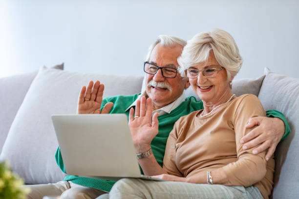 istock Happy senior couple having video call on laptop. 1285526661