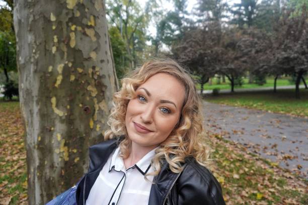 istock A smiling girl walks in the park 1285526755