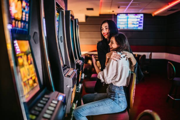 istock Friends playing on slot machines 1285527551
