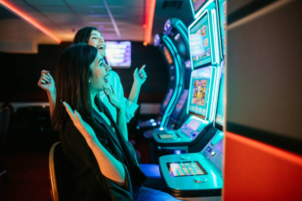 istock Friends playing on slot machines 1285527562