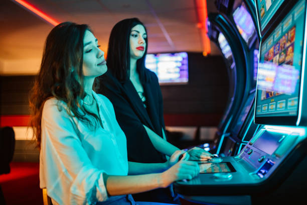 istock Friends playing on slot machines 1285527567