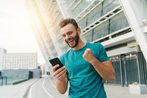 istock Young bearded man showing sincere excitement about his favorite team victory 1285530703