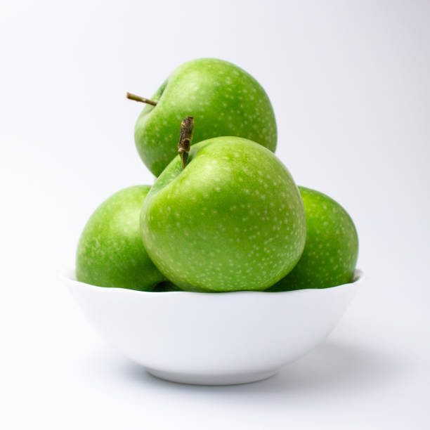 istock Green apples in white plate 1285530859