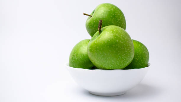 istock White plate of green ripe apples 1285530865