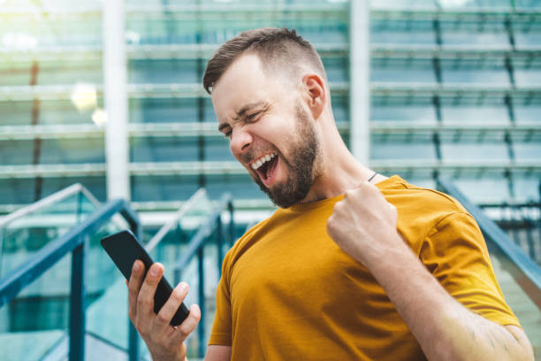 istock Lucky man celebrating victory after making bets using gambling mobile application on his phone 1285531108
