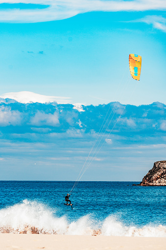 This is Kite Foiling at Praia do Martinhal, Sagres, Portugal\nKite surfing and Kite boarding as well as foiling are getting more and more popular besides surfing. Portugal is the place-to-be in Europe to be able to do it the whole year.
