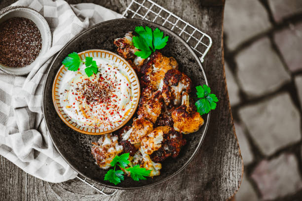 Homemade Vegan Buffalo Wings with Yogurt Dip Homemade Vegan Buffalo Wings with Yogurt Dip – it's the vegan version of Chicken Wings made out of cauliflower low carb diet photos stock pictures, royalty-free photos & images