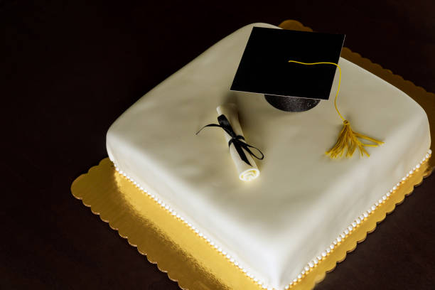 istock Graduation cake with cap on the top and diploma decor. 1285533371