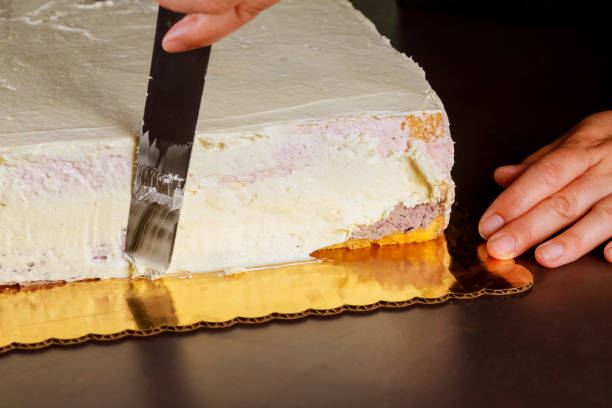 istock Covering layer cake with sweet cream. Making layer sponge cake. 1285533379