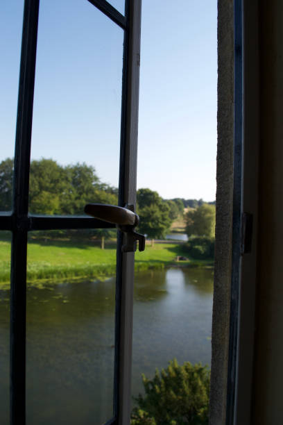 istock Looking out of an open window at a lake / river 1285534212