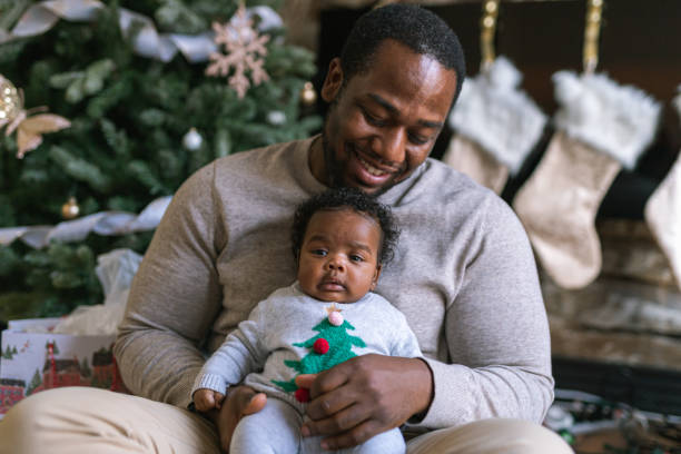 istock A dad hugs his newborn daughter on Christmas Day 1285534233
