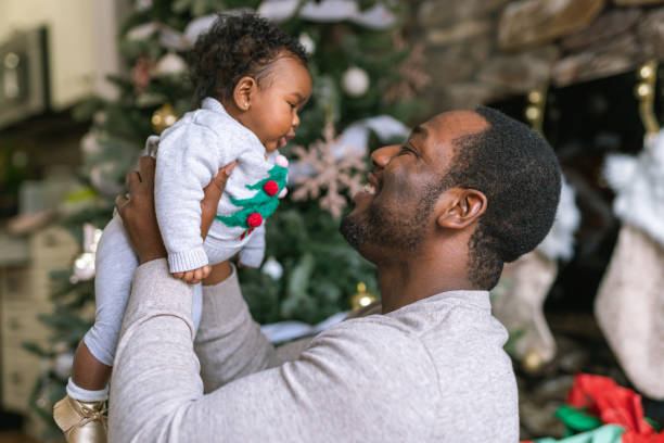istock A handsome dad enjoys spending time with his newborn daughter on Christmas Day 1285534235