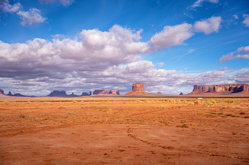 A Billowy, Winter Cloud Scape On A Royal Blue Sky Over The Iconic Monuments Of Monument Valley, Utah, Arizona