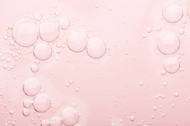 Transparent texture of moisturizing serum on a pink background. Gel water lotion for skincare. Cosmetic liquid beauty product with retinol and vitamins for face and body skin care. Transparent texture of moisturizing serum on a pink background. Gel water lotion for skincare. Cosmetic liquid beauty product with retinol and vitamins for face and body skin care blood serum photos stock pictures, royalty-free photos & images