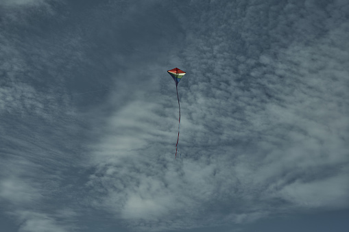 Beautiful kite in the sky against the background of clouds. Passion and hobby. Spending time in nature