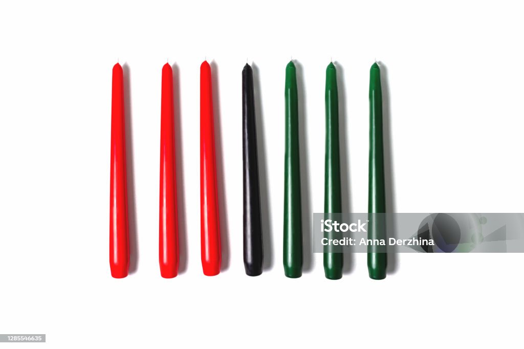 Kwanzaa traditional candles. Isolated on white. Kwanzaa candles on white background. Afro-American holiday. Seven candles as symbol of principles of African Heritage. Mishumaa Saba Stock Photo