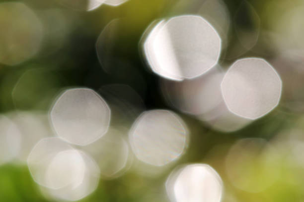istock Glittering blurred green and white background with luminous dots 1285549688
