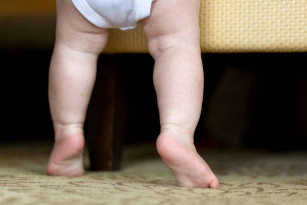 istock Barefoot child standing on the soft carpet. 1285561511