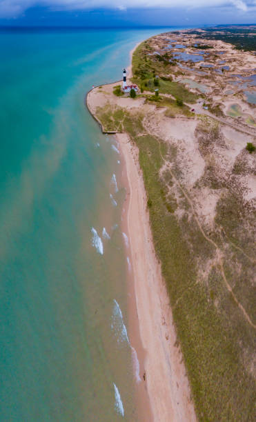 An aerial view of the lighthouse beaches and dunes at Ludington State Park in Ludington, MI stock photo