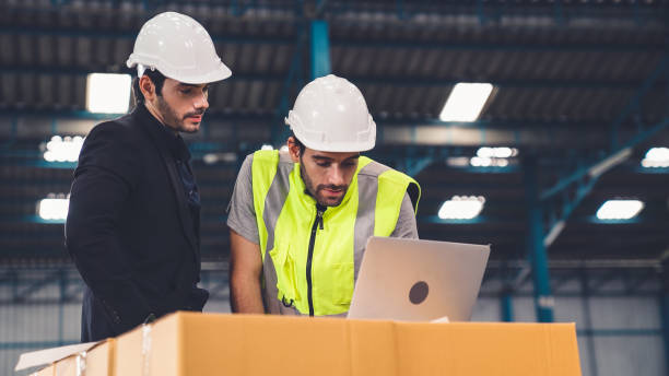 istock Two factory workers working and discussing manufacturing plan in the factory . 1285568682