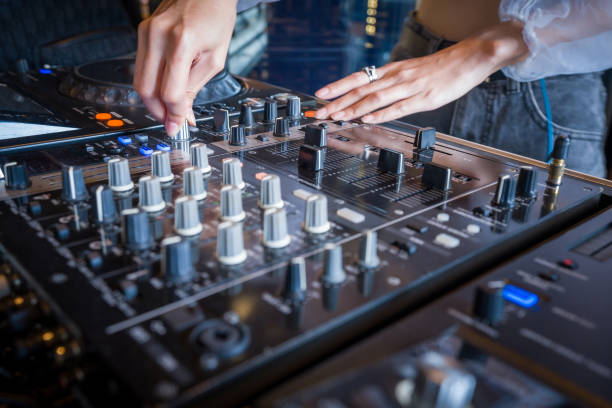 istock Dj raises volume on sound mixer panel at the party. 1285569457