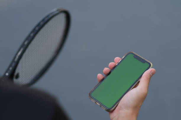 istock people holding green screen smart phone while playing tennis 1285570926
