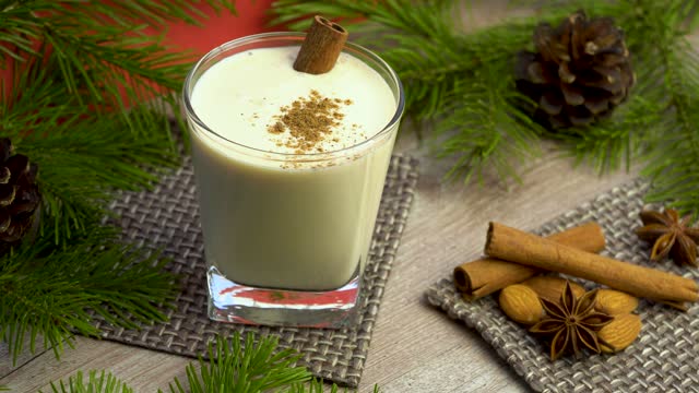 eggnog Christmas cocktail with grated nutmeg and cinnamon. Traditional holiday drink. warm xmas cocktail made on the basis of milk,cream, eggs and spices, with the addition of alcohol.