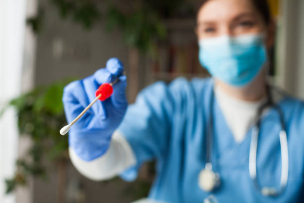 istock Doctor performing COVID-19 swab test 1285577438