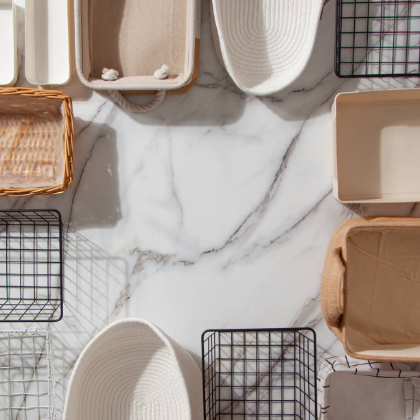 Top view of closet organization boxes and steel wire baskets in different shapes Top view of empty closet organization boxes and steel wire baskets in different shape placed on white marble table with copy space. modern boxes for tidying clothes and drawer storage nature russia environmental conservation mineral stock pictures, royalty-free photos & images