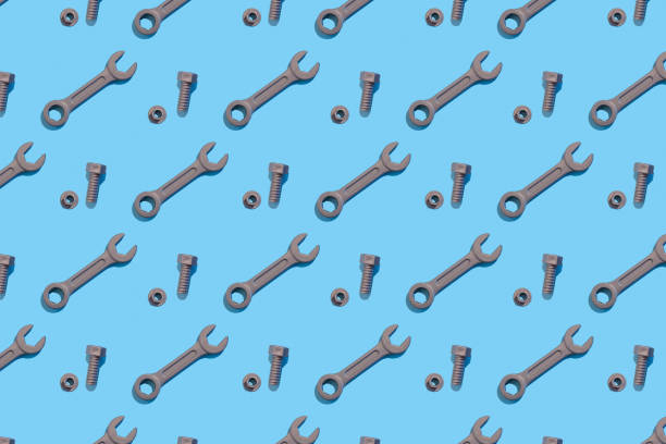 istock Seamless regular pattern with wrench, bolt and nuts on a blue background. Hard light. Father's day holiday concept. 1285581969